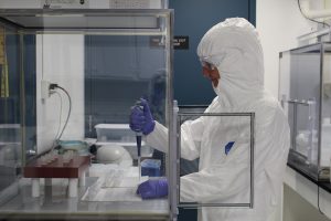 A scientist uses a pipet in a lab