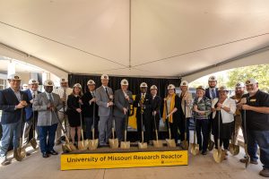 A group photo of state and community leaders with shovels for a symbolic groundbreaking.