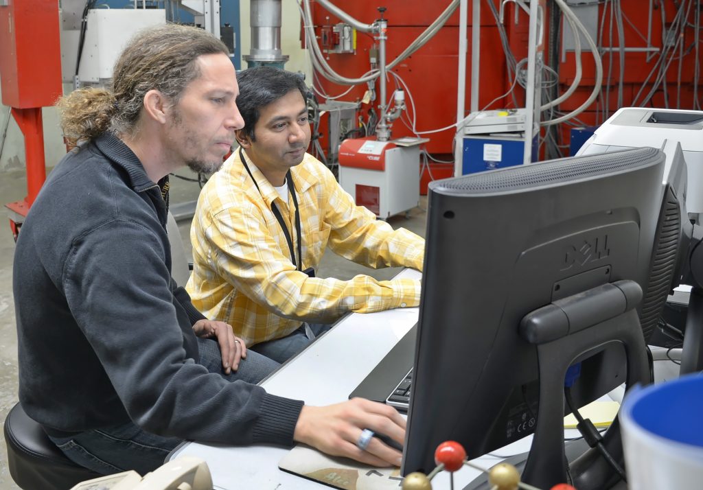 two men working at a computer
