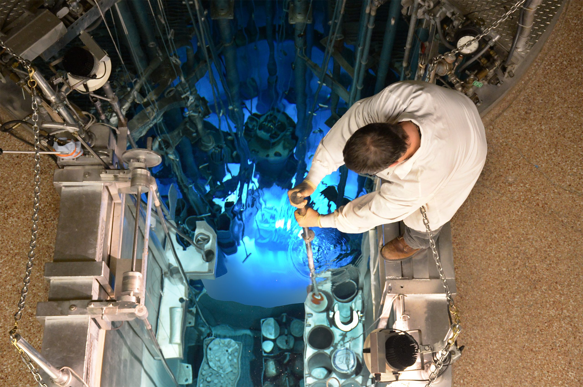 a man moves a sample in the containment pool