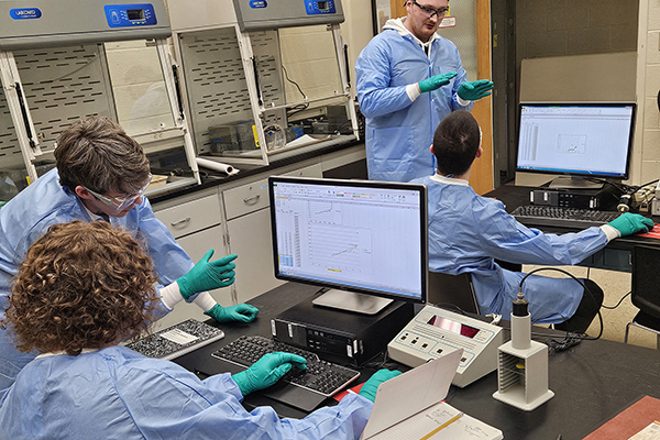 students and teachers in a radiochemistry lab