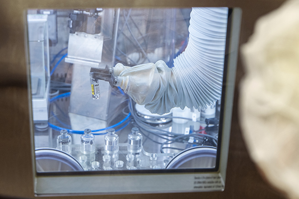 A manipulator handles a sample in a hot cell